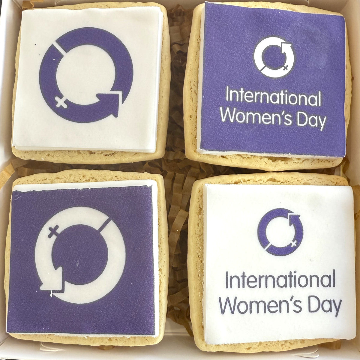 Four square branded cookies in a box, International Women's Day artwork