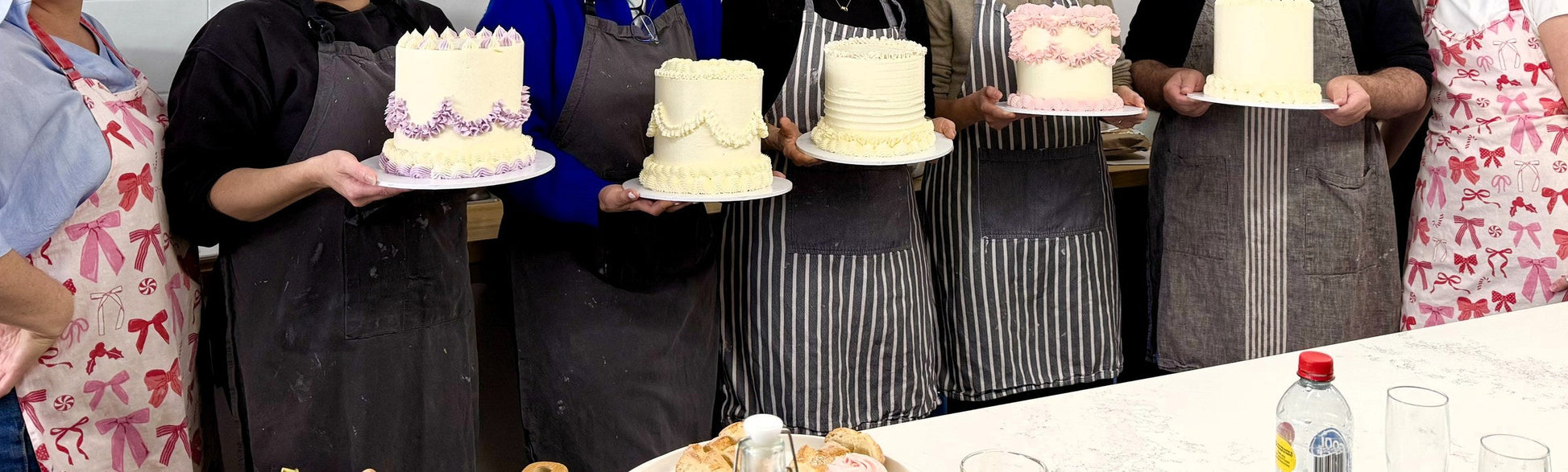 Five finished buttercream cakes decorated by guests at the Rozelle studio