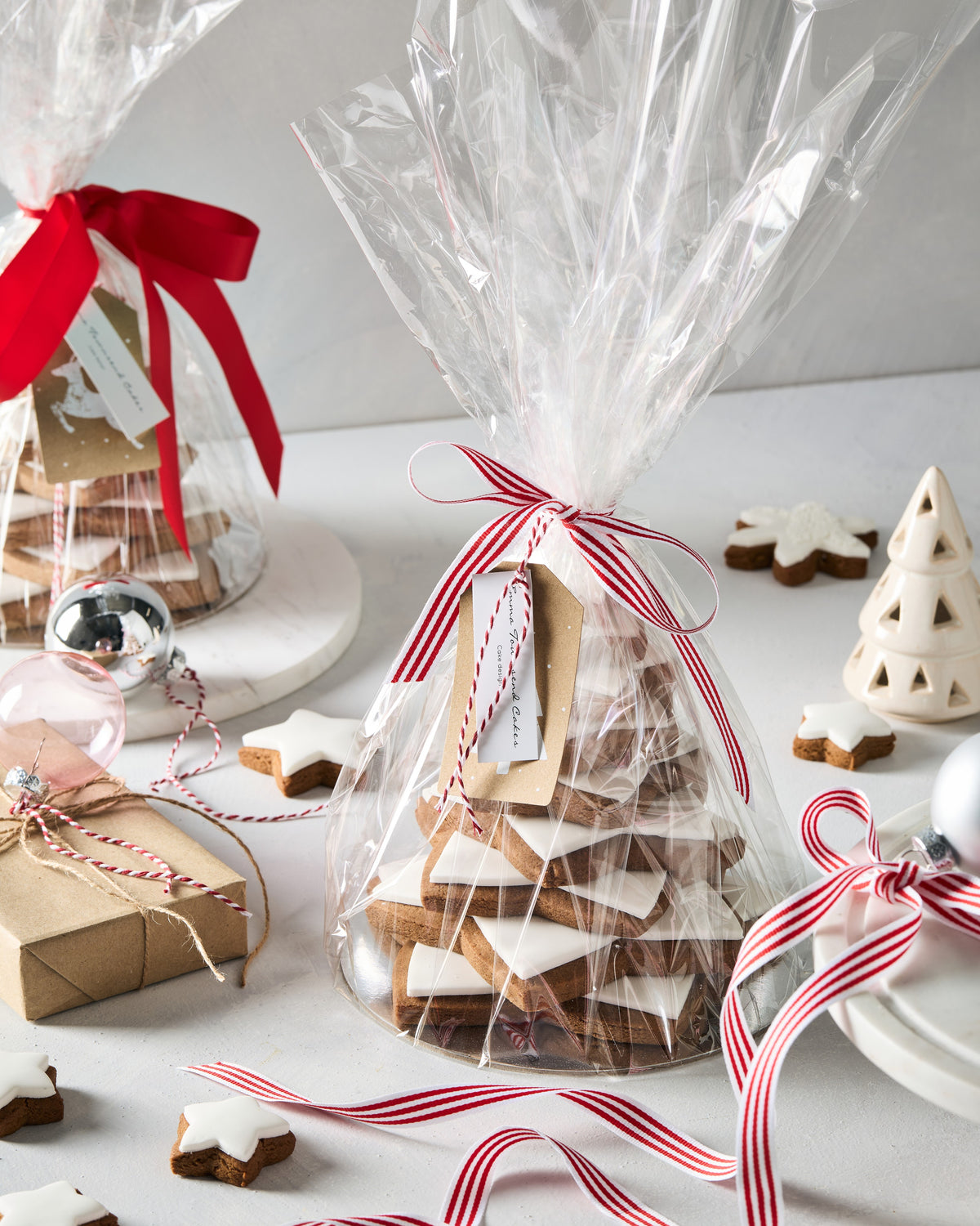 Gingerbread star tree gift wrapped in cellophane with a red and white striped ribbon and gift tag